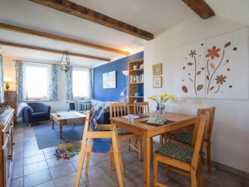 a dining room and living room with a table and chairs at Apartment Nice Holidays by Interhome in Pellworm