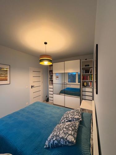 a bedroom with a blue bed in a room at Krapkowice Odrzańskie Tarasy in Krapkowice