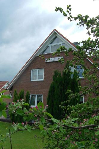 a red brick house with trees in front of it at Apartment Schule 5 by Interhome in Windeby