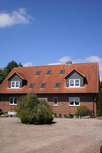 a large house with a red roof with windows at Apartment Schule 4 by Interhome in Windeby