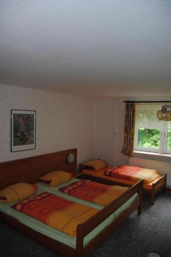 a bedroom with two beds and a window at Apartment Schule 6 by Interhome in Goosefeld