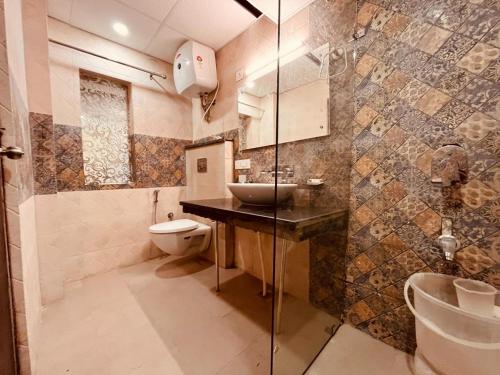 a bathroom with a sink and a toilet at The Pine Mountain View A Rooftop Restaurant & Luxury Balcony Rooms! in Mussoorie