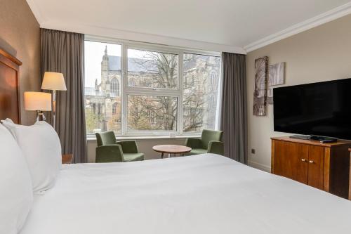 a hotel room with a large bed and a large window at Winchester Wessex Hotel by Sunday in Winchester