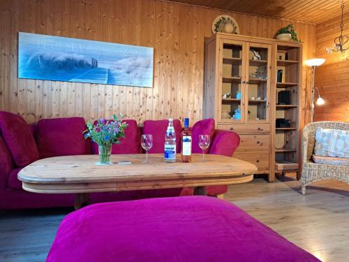 a living room with a table and purple furniture at Holiday Home Barbara by Interhome in Kittlitz