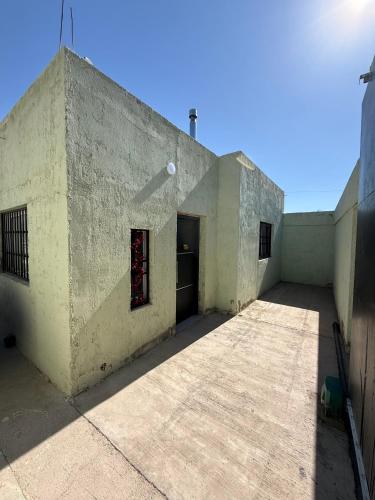 a concrete building with a door in the middle at El Cerrito in Las Heras