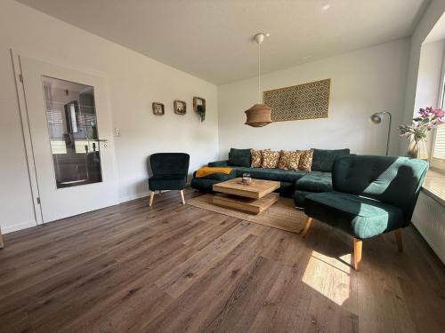 a living room with a couch and a table at Huus Christine in Holtgast
