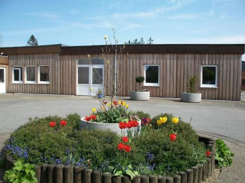 a building with flowers in front of it at Apartment Fewo Edison by Interhome in Holzdorf