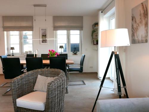 a living room with a table and chairs and a lamp at Holiday Home Knut by Interhome in Mellnitz
