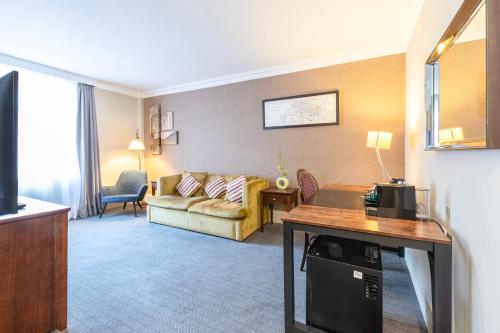 a living room with a couch and a table at Winchester Wessex Hotel by Sunday in Winchester