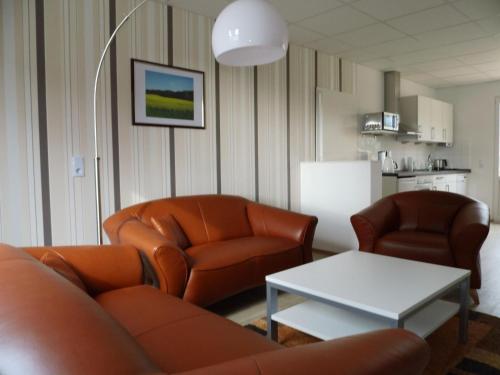 a living room with a couch and two chairs and a table at Apartment Fewo Berliner by Interhome in Holzdorf