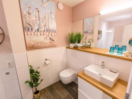 a bathroom with a toilet and a sink at Apartment Appartement mit Terrasse by Interhome in Bracht