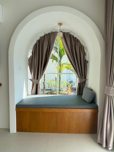 a bed in a room with a window at Hidden Haven Resort Koh Lanta in Ko Lanta