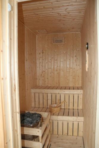 a sauna with wooden walls and shelves in a room at EDC UUM Sintok in Sintuk