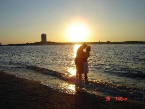 a couple standing in the water on the beach at Apartment in Dassow by Interhome in Feldhusen