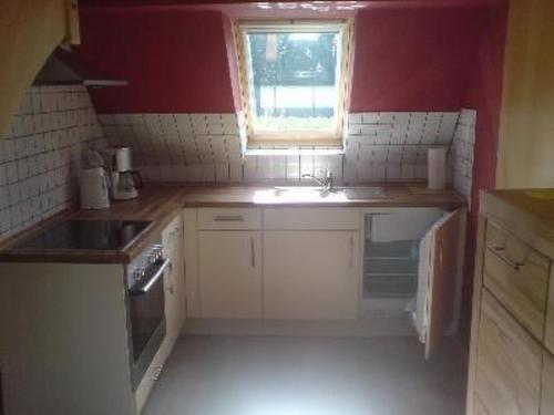 a small kitchen with a sink and a window at Apartment 3 by Interhome in Feldhusen