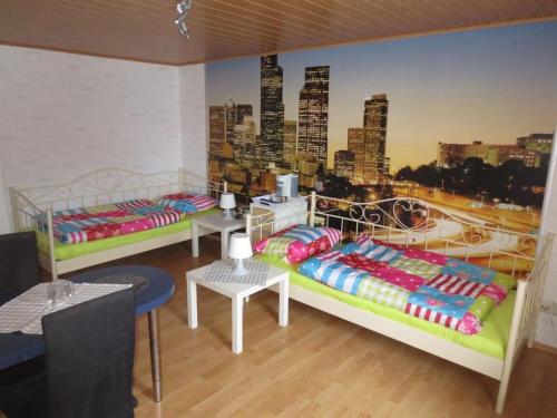 two beds in a room with a mural of a city at Apartment Santa Maria by Interhome in Nettersheim