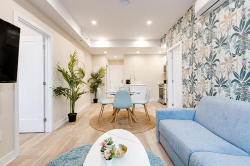 a living room with a blue couch and a table at Mont Royal Suites - M11 in Montréal