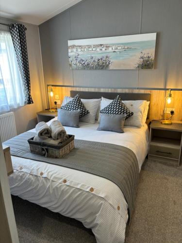 a bedroom with a large bed with a dog laying on it at Seafront Serenity Lodge in Newbiggin-by-the-Sea