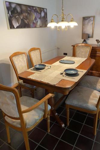 a dining room table with four chairs at Apartment Schomaker-Fatmann by Interhome in Rastdorf