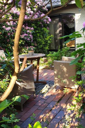 a table and two chairs on a brick patio at Apartment Schomaker-Fatmann by Interhome in Rastdorf
