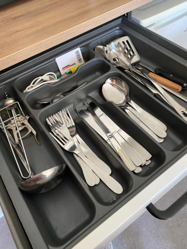 a drawer full of utensils in a kitchen drawer at La loge Royale in Cucq