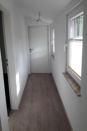 an empty room with a door and a window at Apartment Am Wald by Interhome in Westerstede