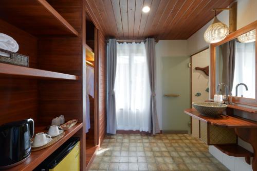 a kitchen with a sink and a window in it at PingChan Koh Phangan Beachfront Resort in Thong Nai Pan Yai