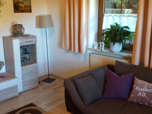 a living room with a couch and a window at Apartment FeWo Steinbeisser by Interhome in Arrach