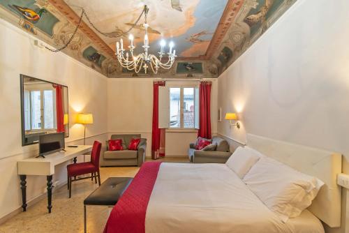 a hotel room with a bed and a desk at Duomo View in Florence