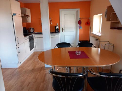 a kitchen and dining room with a table and chairs at Apartment Mooij Plaats by Interhome in Großefehn 