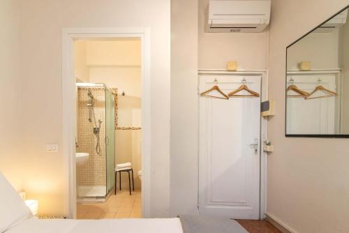 a bedroom with a door leading to a bathroom at Duomo View in Florence