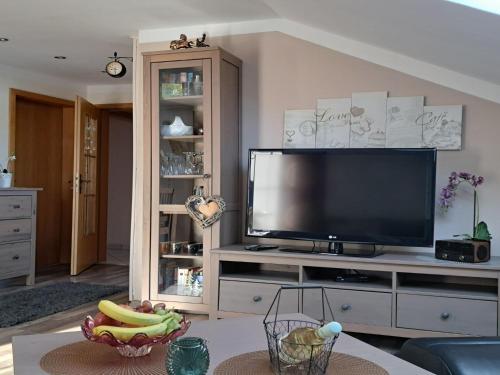 a living room with a flat screen tv on a entertainment center at Apartment FeWo Steinbeisser by Interhome in Arrach