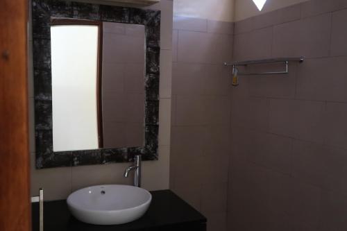 uma casa de banho com um lavatório e um espelho em Bali Reef Divers Tulamben em Tulamben