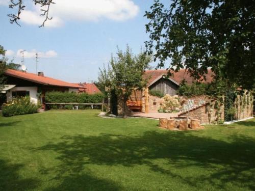 a yard with green grass and a house at Apartment Bärli by Interhome in Bad Bayersoien