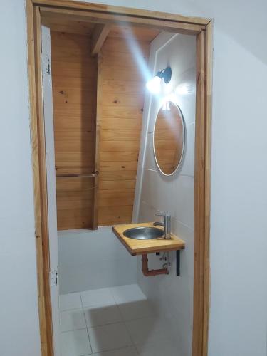 a bathroom with a sink and a mirror at Cabañas Amapola del 66 in Miramar