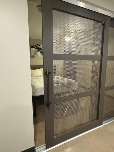 a sliding glass door with a window in a room at Iron City Loft in Birmingham