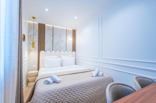 a bedroom with a bed with blue towels on it at Garbo hotel in Paris
