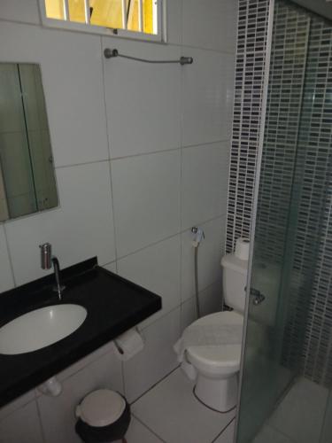 a bathroom with a sink and a toilet at Brisa Brasil Residence in Fortaleza