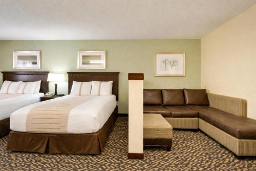 a hotel room with a bed and a couch at Fireside Inn and Suites in Devils Lake