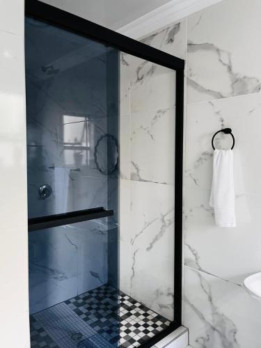 a shower with a glass door in a bathroom at 4 at Granada 1 in East London
