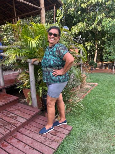 a man standing next to a bunch of bananas at RECANTO DO SABIÁ in Carolina