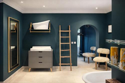 a bathroom with blue walls and a ladder and a sink at Glandwr hall - 6 Bed - Magnificent Country House with Heated Swimming Pool & Jacuzzi in Barmouth