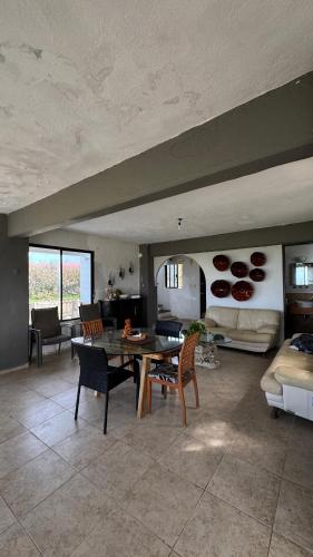 a large living room with a table and chairs at Beach chalet with Private Pool in Heroica Alvarado