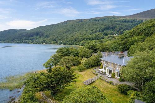 an aerial view of a house on the edge of a lake at Glandwr hall - 6 Bed - Magnificent Country House with Heated Swimming Pool & Jacuzzi in Barmouth