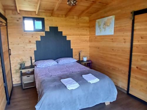 a bedroom with a bed with two towels on it at Cabaña Martina con Jacuzzi in Marinilla