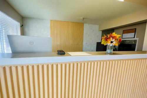 a lobby with a counter with a vase of flowers on it at Red Lion Inn & Suites Junction City in Junction City