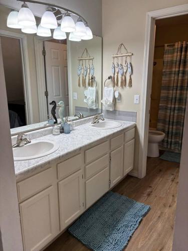 a bathroom with a sink and a large mirror at Branson Lakeside Getaway in Branson