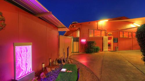 a house with purple lights on the side of it at Halls Creek Motel in Halls Creek
