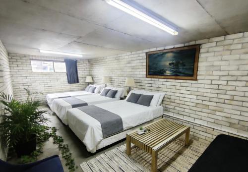 a bedroom with a large bed in a brick wall at Burwood central home in Sydney