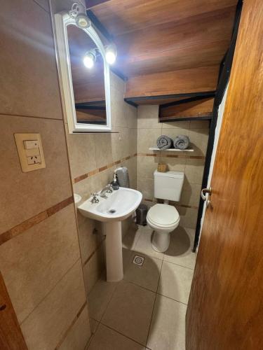 a small bathroom with a sink and a toilet at Cava del Sur in San Rafael